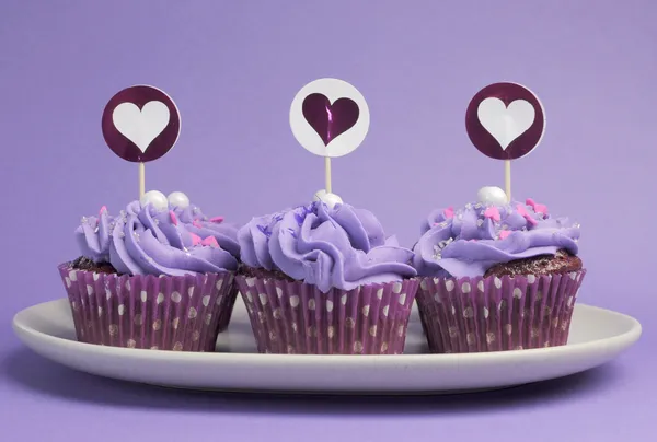 Mauve purple decorated cupcakes for children or teens birthday, or bachelorette, bridal or baby shower party function.