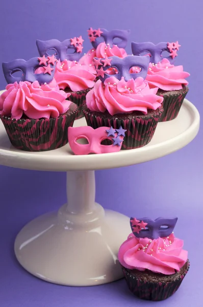 Pink and purple masquerade masks decorated party cupcakes