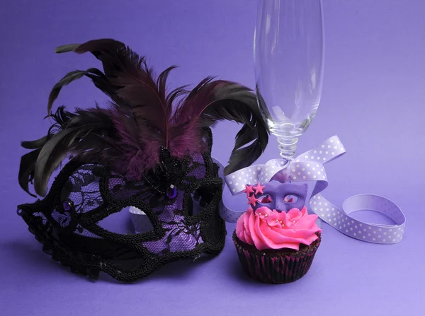 Pink and purple masquerade masks decorated party cupcake