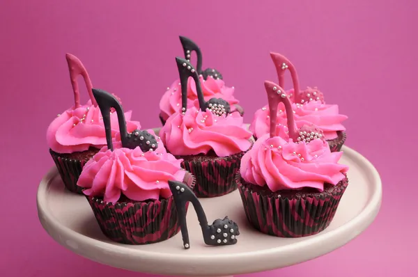 Female high heel shoes decorated pink and black red velvet cupcakes
