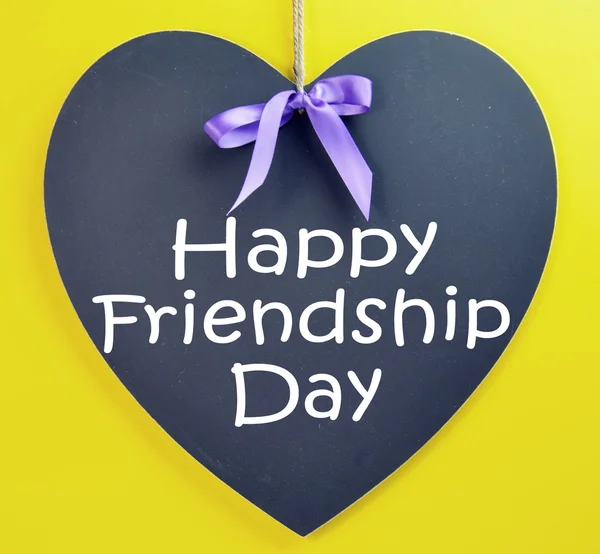 Celebrate International Friendship Day on August 4, with a Happy greeting on a heart shape blackboard