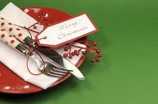 Traditional red and green Christmas lunch or dinner table place setting.