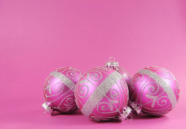 Beautiful fuchsia pink Merry Christmas bauble ornaments with copy space.