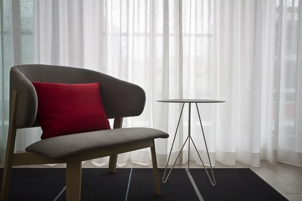 Contemporary interior grey chair sheer curtains