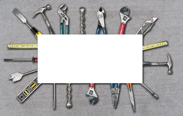 Various used tools on concrete background