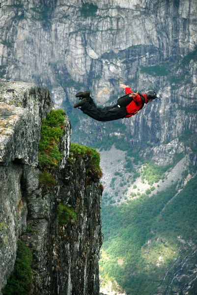 BASE jump off a cliff.