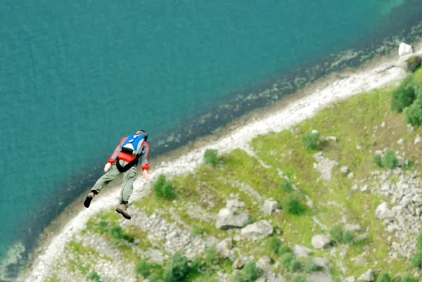 BASE jump off a cliff.