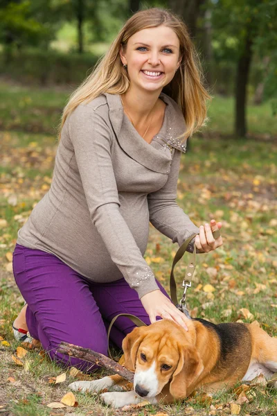 Attractive young woman playing with her pet