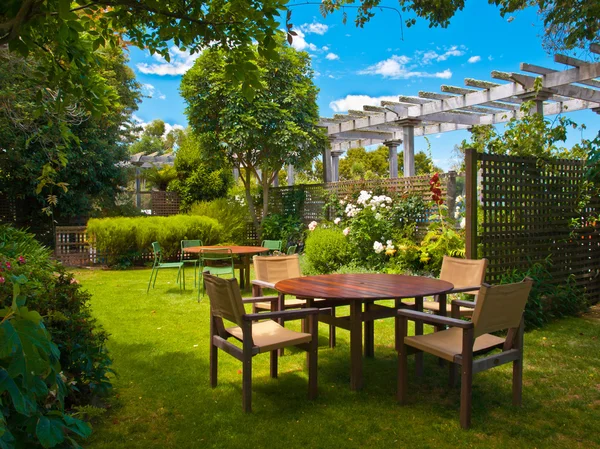 Dining table set in lush garden