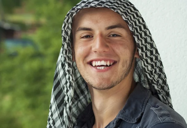 Young muslim man with scarf on head outdoor