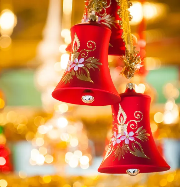 Red Christmas-bell hanging at tree - golden background