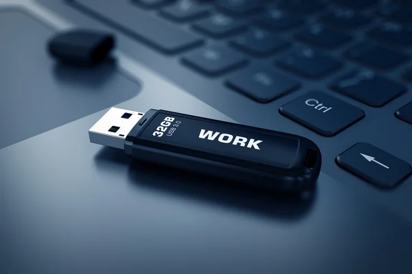 Modern USB Flash drive on laptop keyboard
