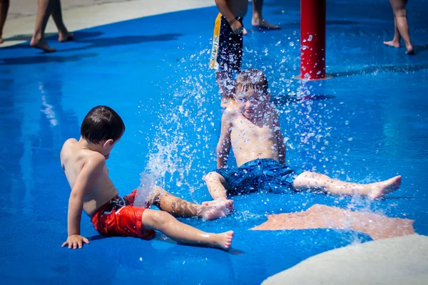 Two boy having fun at a splash pad