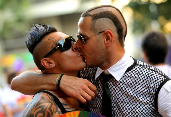 Two young men kissing during the annual Barcelona Gay and Lesbian Pride Festival