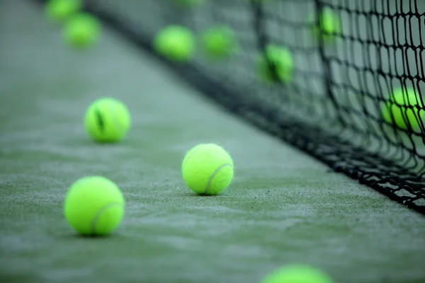 Tennis or paddle balls on synthetic grass