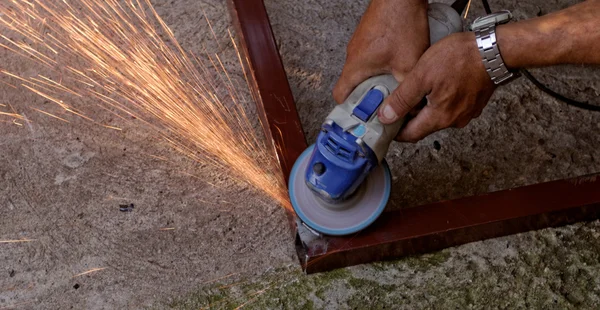Hand grinder buffing the steel