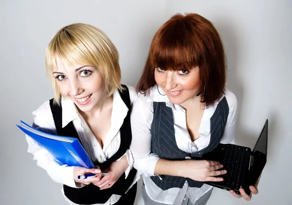 Two woman with folder and laptop