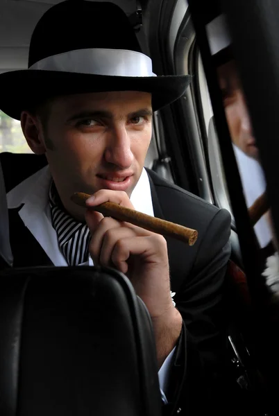 Man with cigar in the car