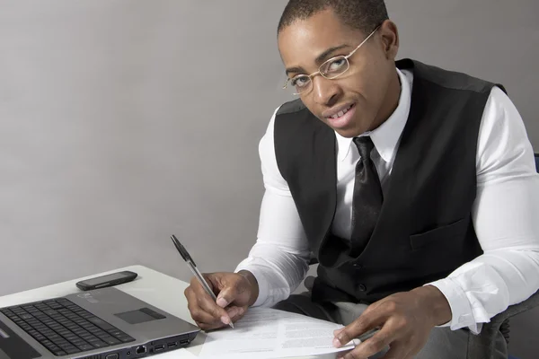 Young Black Man writing on a document
