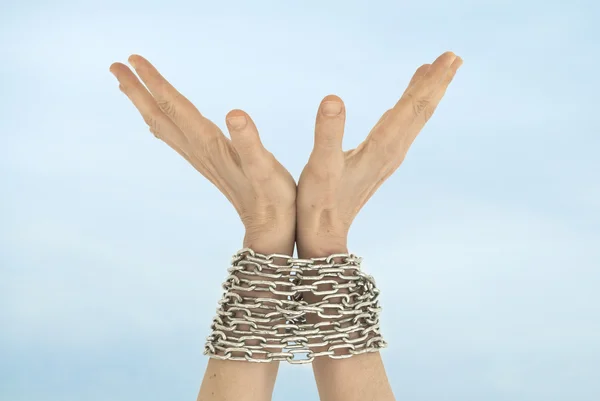 Chained hands and sky