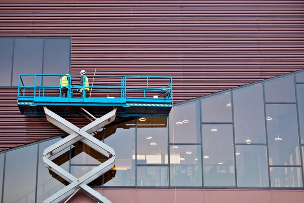 Builder on a Scissor Lift Platform at a construction site