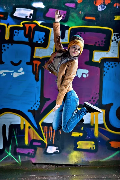 Pretty young girl and graffiti