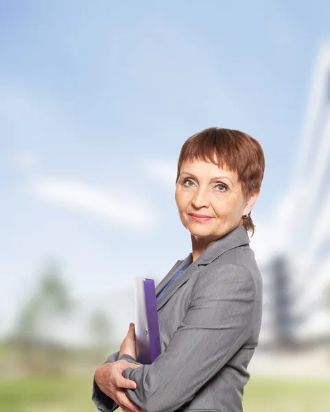 Attractive woman 50 years old with a folder for documents