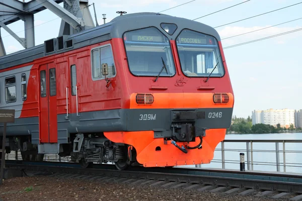 VORONEZH - MAY 12: Russian Railways commuter electric train passes bridge in Voronezh on May 12, 2013. Electric train ED9M route Voronezh - Liski passes steel bridge at the Voronezh reservoir.