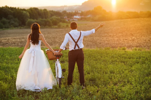 Bride and groom with a white wedding bike