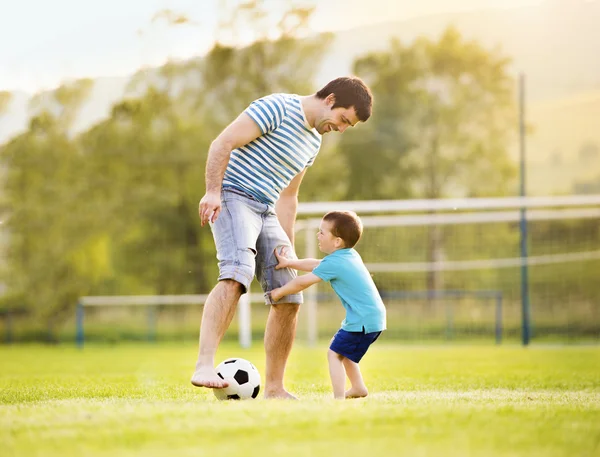 Father with son playing football