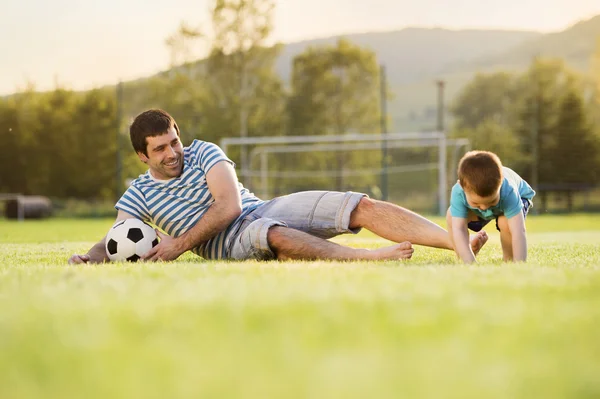 Father with son playing football