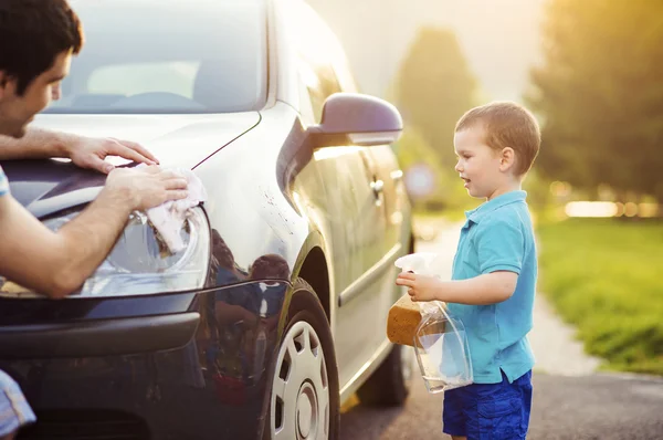 Father with son washing car