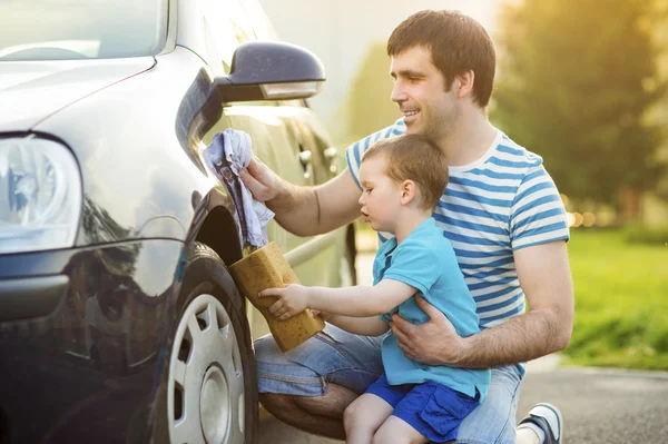 Father with son washing car