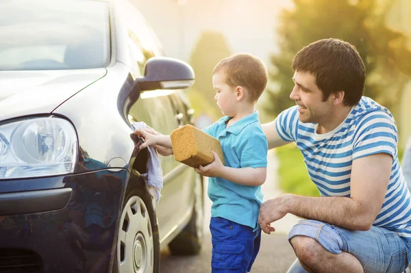 Father with son washing car