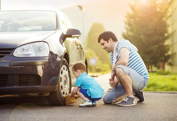 Father with son washing car