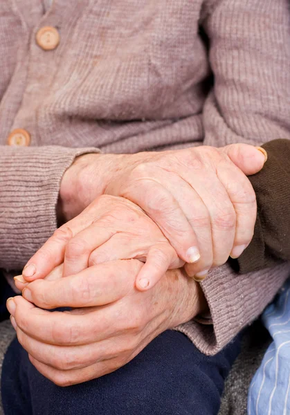 Old couple holding the hands