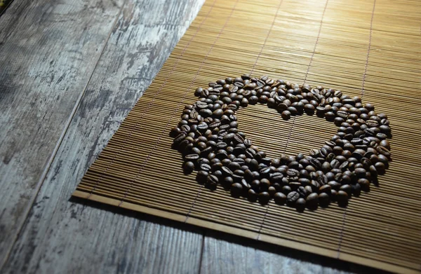 Heart coffee frame made of coffee beans on a vintage background