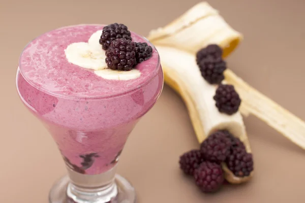 Сocktail of banana with frozen blackberries and yogurt.