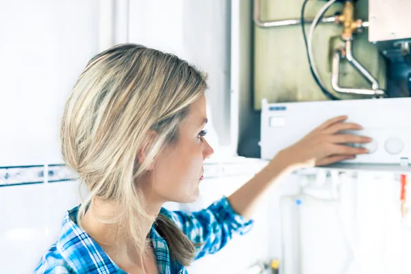 Beautiful Girl Is Seting Up a Boiler