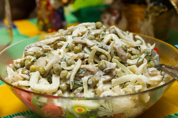 Squid salad with mushrooms and green pepper in a bowl