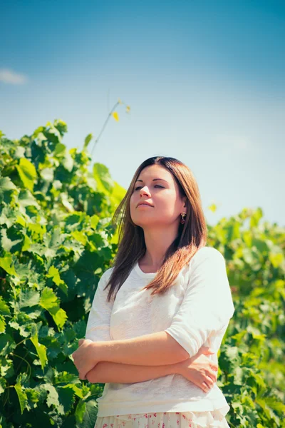 Woman  walks on a vineyard