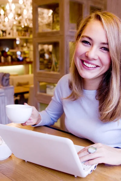 Smiling young woman with computer