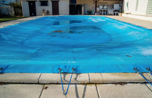 Pool protected by a pool cover during winter months