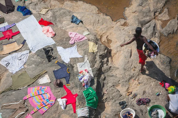 Madagascan woman washing clothes in a river