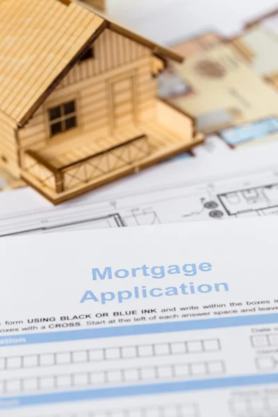 House mortgage application with model house and construction pla
