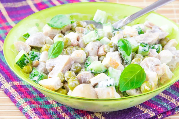 Salad with green peas, chicken, mushrooms, cucumber and mayonnai