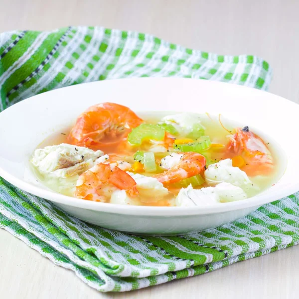 Fish soup with shrimps, white fillet of cod and perch, celery, c