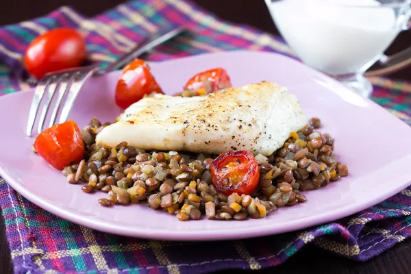 White fish fillet of perch, cod with vegetables and lentils, tom