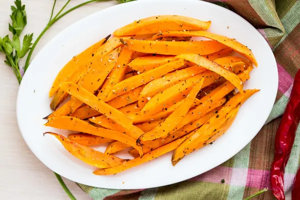 Sweet potatoes, batata, sliced, fried in pan with spices, herb