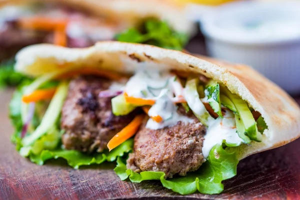 Minced meat kebab, beef balls in flat cake with vegetable